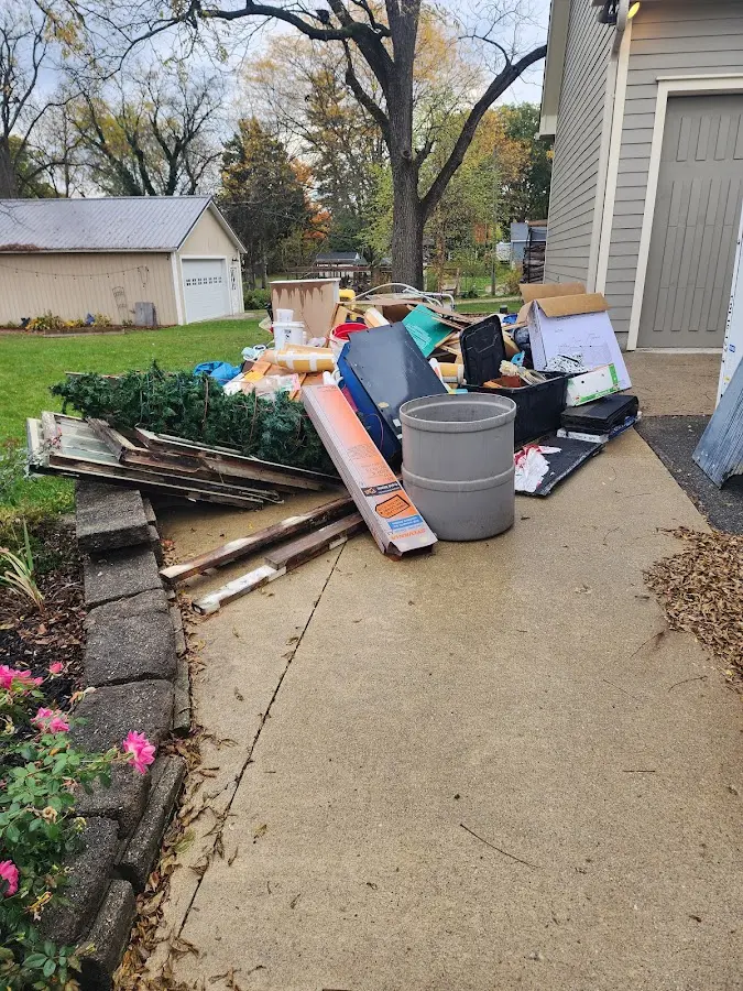 Dumpster being loaded with debris for Commercial Dumpster Rental in Muskegon